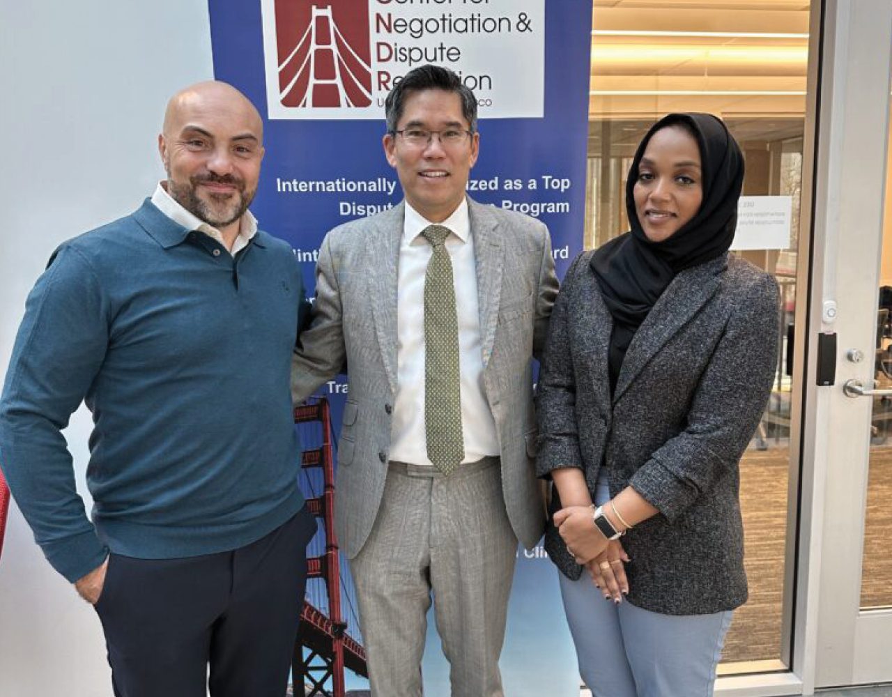 Three ADR professionals smile at the camera