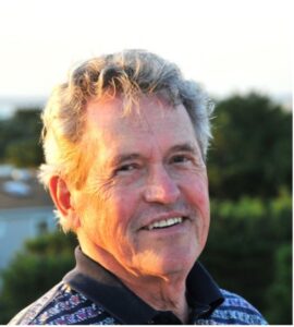 A headshot phot of William Hutton in an outdoor setting