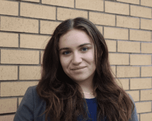 3L student Isabel Samayoa wearing a blazer in front of a brick wall.