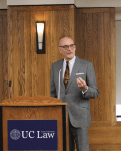 Matt Coles stands behind a lecturn to deliver a speech