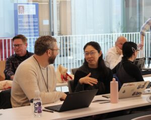 Program participants engage in one-on-one discussions in a classroom.