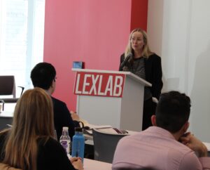 Cornelia Kutterer speaks at the front of a classroom behind a podium