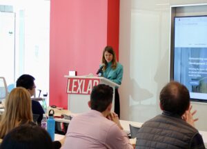 Tal Niv speaks at the front of a classroom behind a podium
