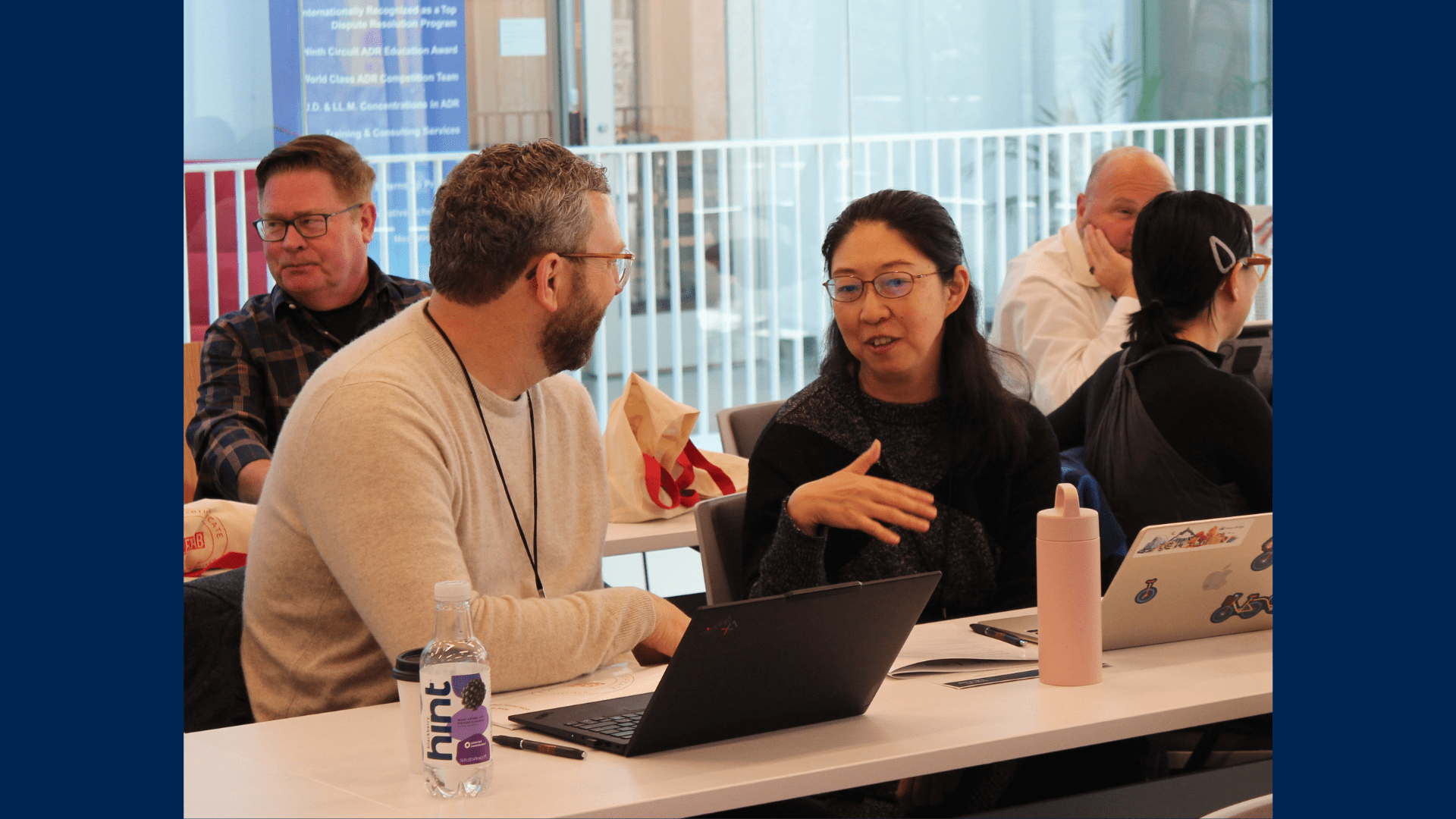 Program participants engage in one-on-one discussions in a classroom.