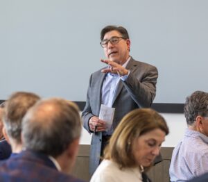 David Faigman speaks with expressive hand gestures during an alumni luncheon event.