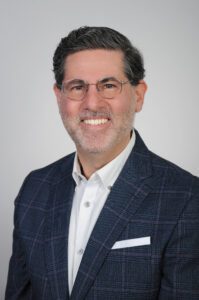This is a headshot of Professor Jeffrey Lefstin, wearing a suit and glasses in front of a white background.