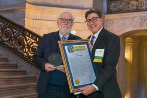 Jim Wagstaffe with David Faigman holding the Chancellor's Alumni of Distinction award