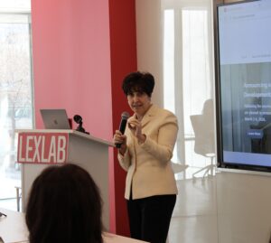 Robin Feldman speaks at the front of a classroom behind a podium