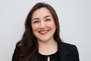 This photo is a headshot of 3L Saamia Aziz wearing a black shirt and smiling.