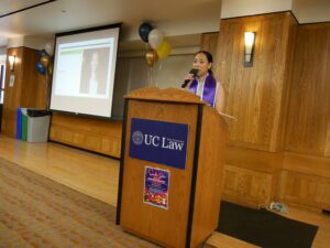 Grace Perez speaking at the podium in the Alumni Reception Center