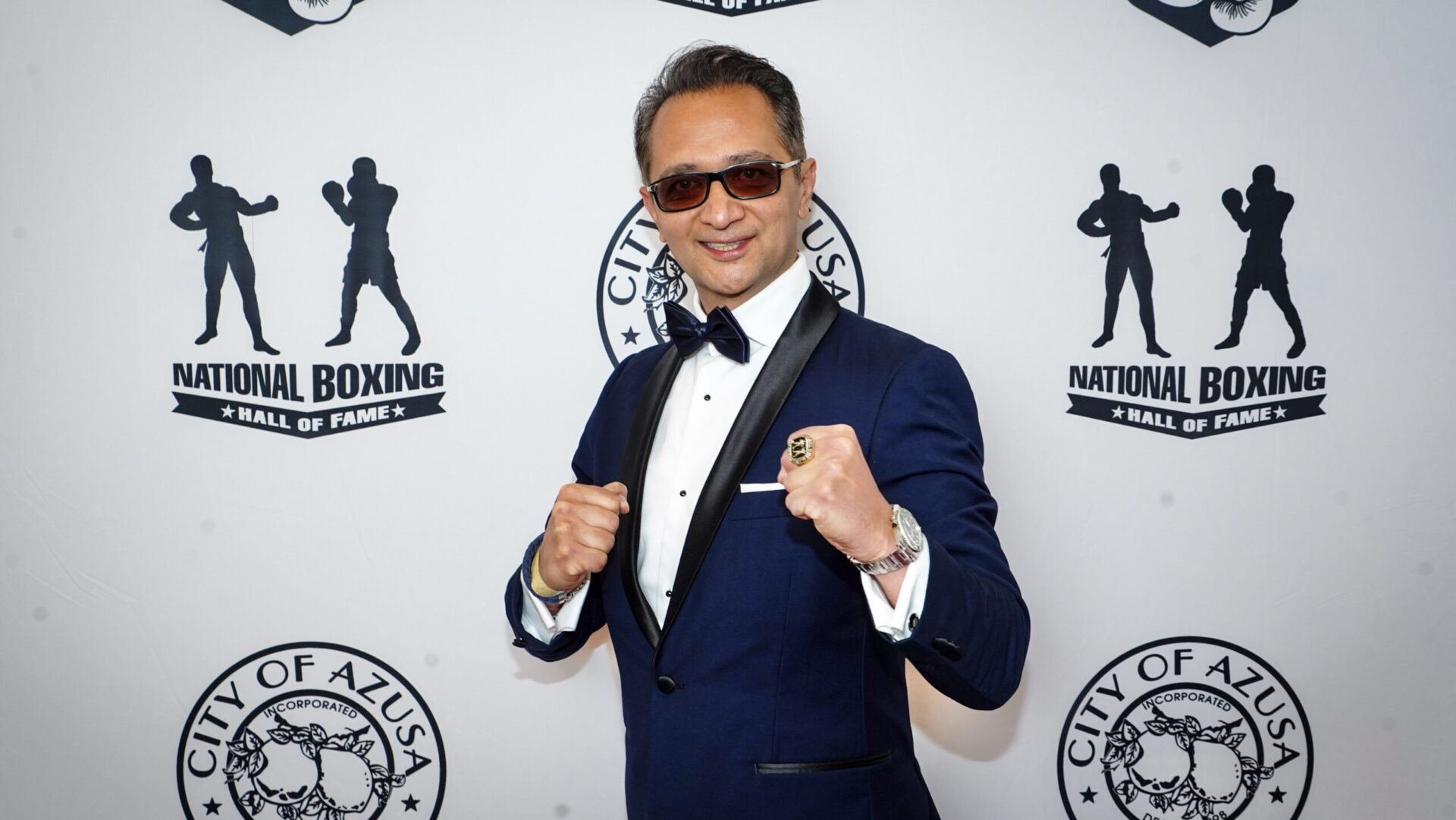 Farzad Tabatabai ’95 poses with his fists up at a boxing hall of fame ceremony.