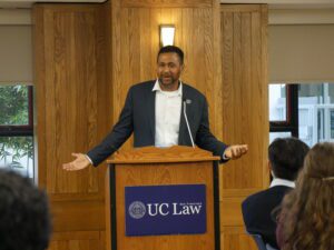 Andrew Houston speaks at a podium.