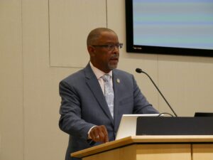 Troy Nunley speaking at the podium in the 198 McAllister auditorium