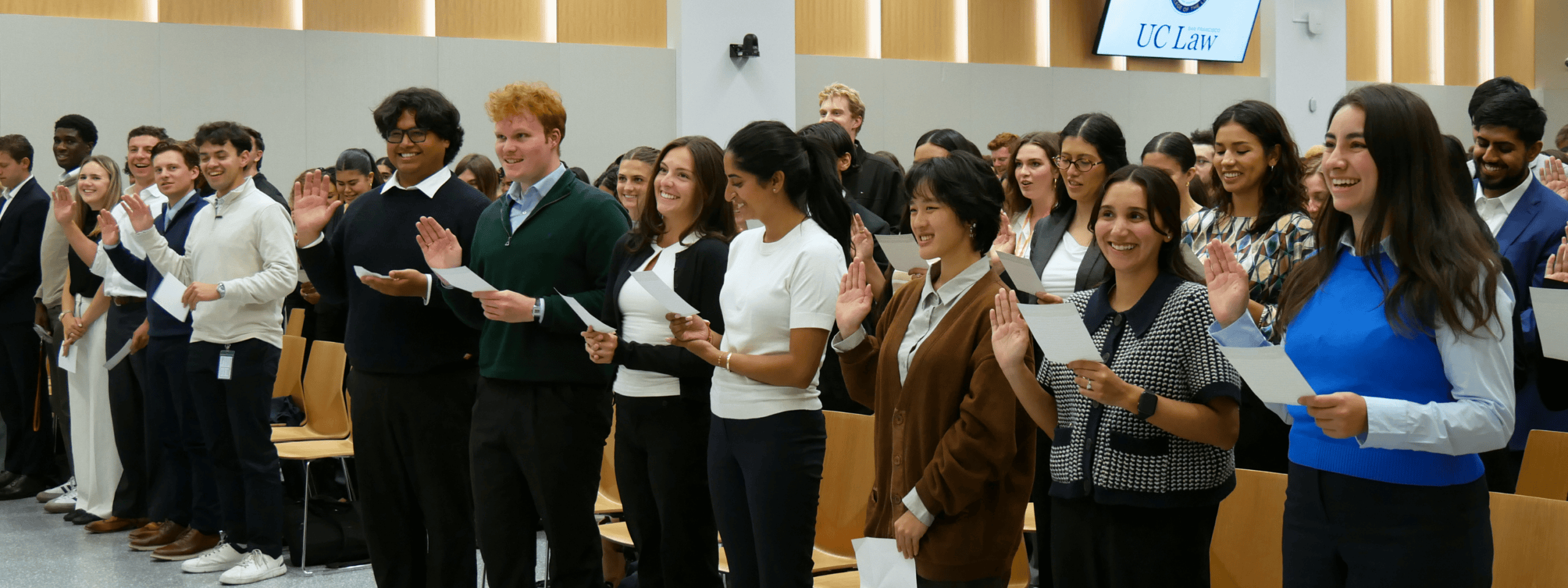 The 198 McAllister auditorium filled with 1Ls holding up their right hand and reading off their professional oath card