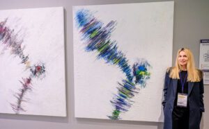 Ana-Maria Gower poses next to her artworks.
