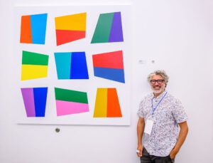 Pablo Manga poses next to his artwork.