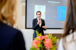 Scott Wiener speaks holding a microphone.