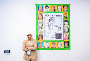 William Rhodes poses next to his artwork.