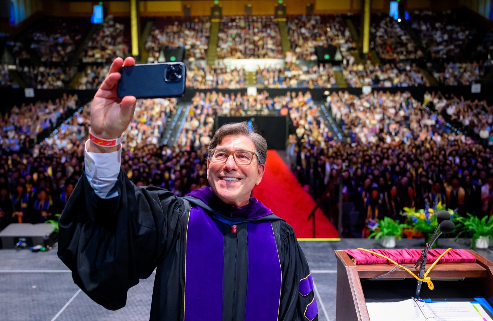 Chancellor & Dean David Faigman taking a photo of the graduating class