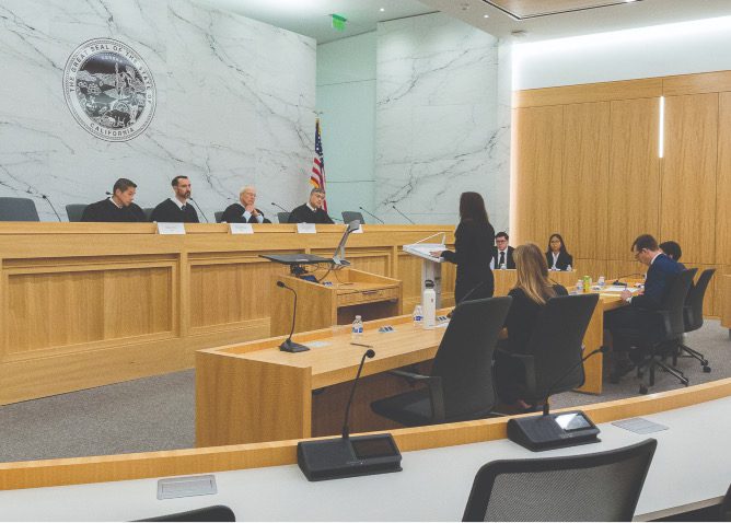 Students arguing a case in a moot courtroom